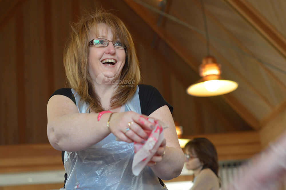 Lady laughing on Team Bake Off team building event