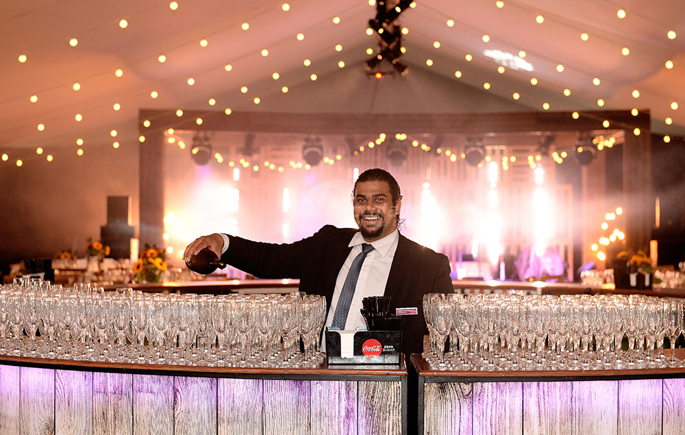 Country Chic Corporate Event Barman Pouring Champagne