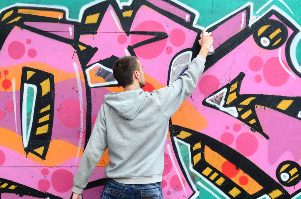 Man painting graffiti for Graffiti workshop event