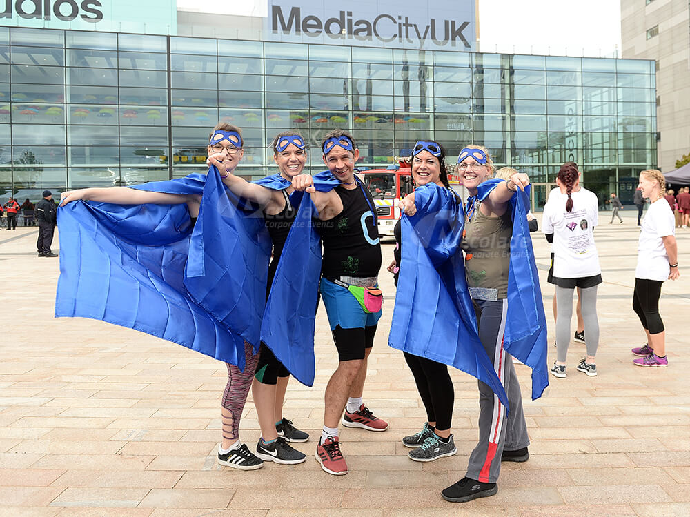 Team in superhero costumes for It's a Knockout team building event