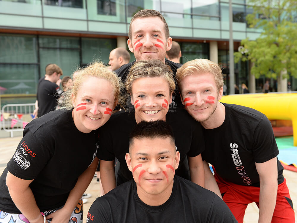 Team posing for its a knockout total wipe out team building event