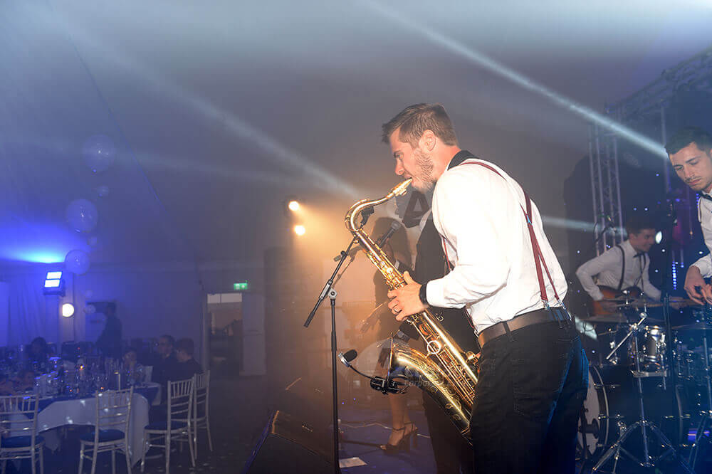 Male saxophonist playing at corporate party event