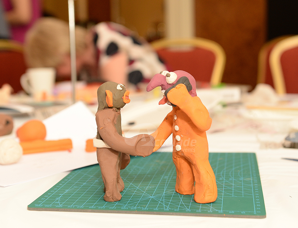 Two Plasticine men shaking hands in Team Animation event