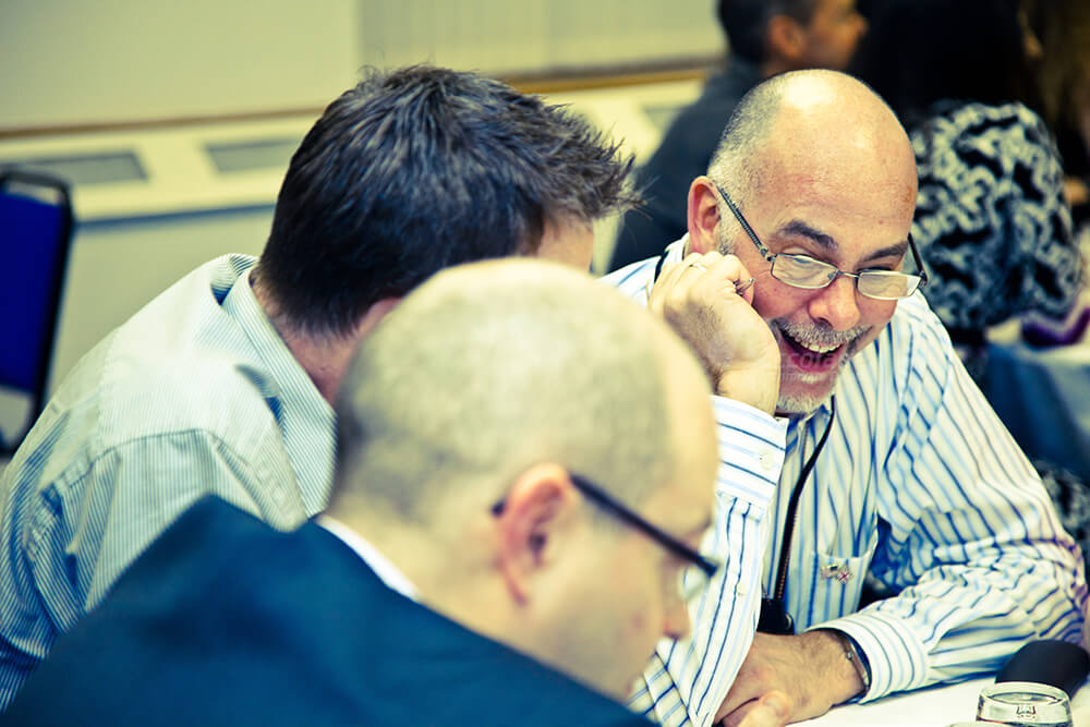 Man laughing at team apprentice corporate event