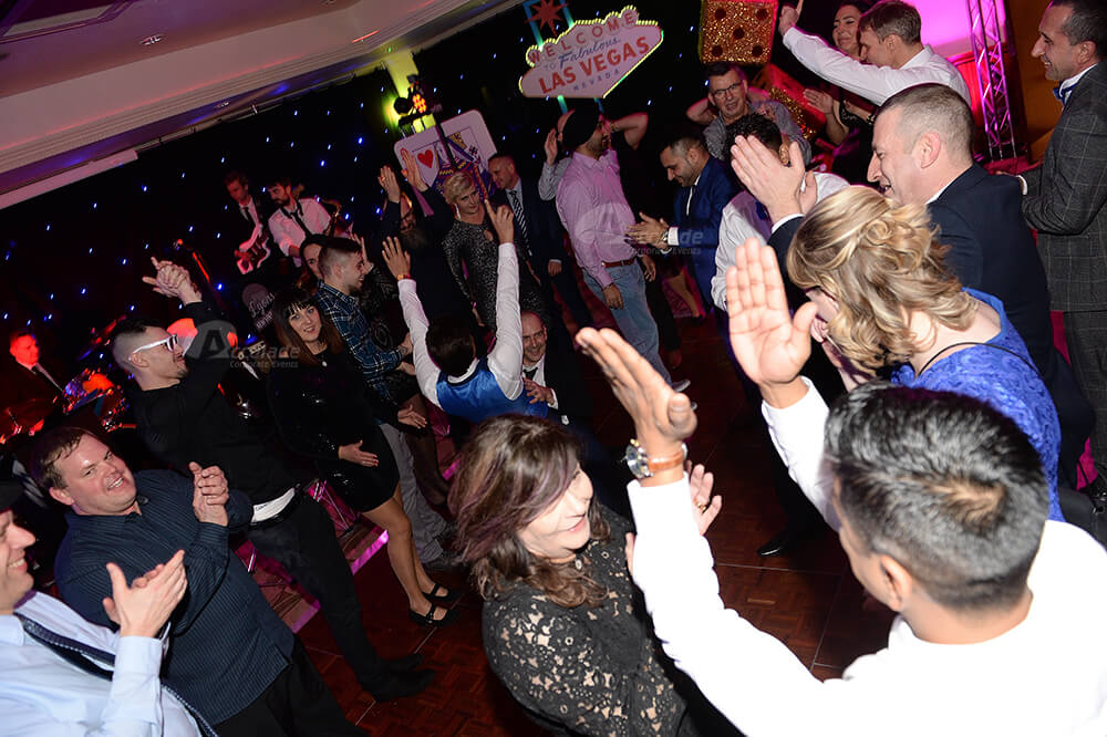 People dancing and clapping at company party
