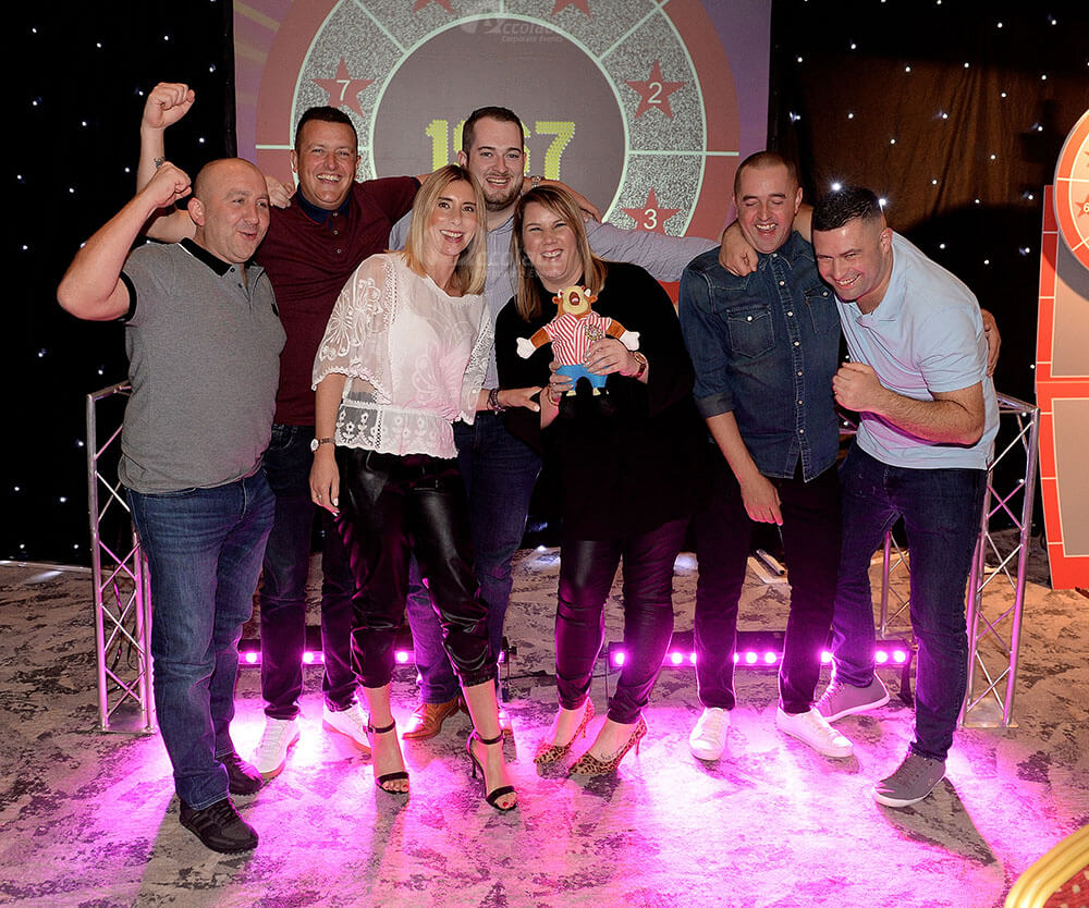 Team smiling at corporate game show event