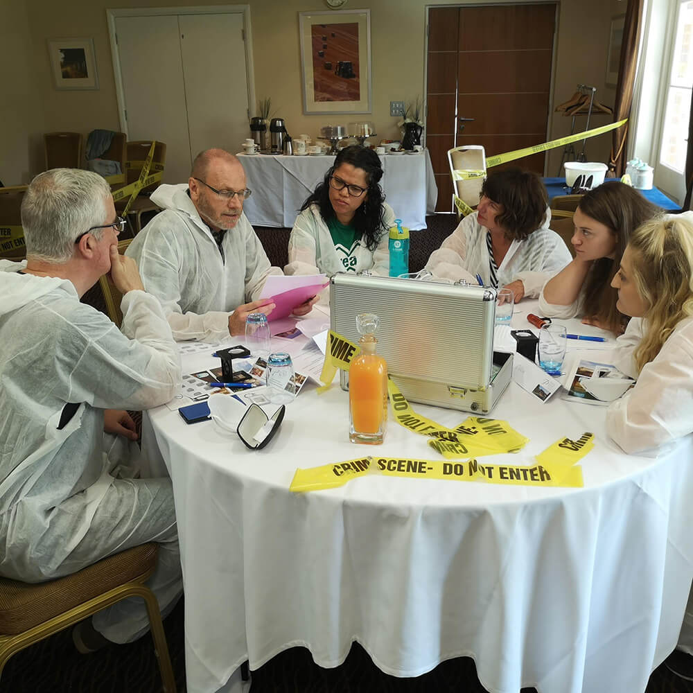 Team discussing crime at corporate event