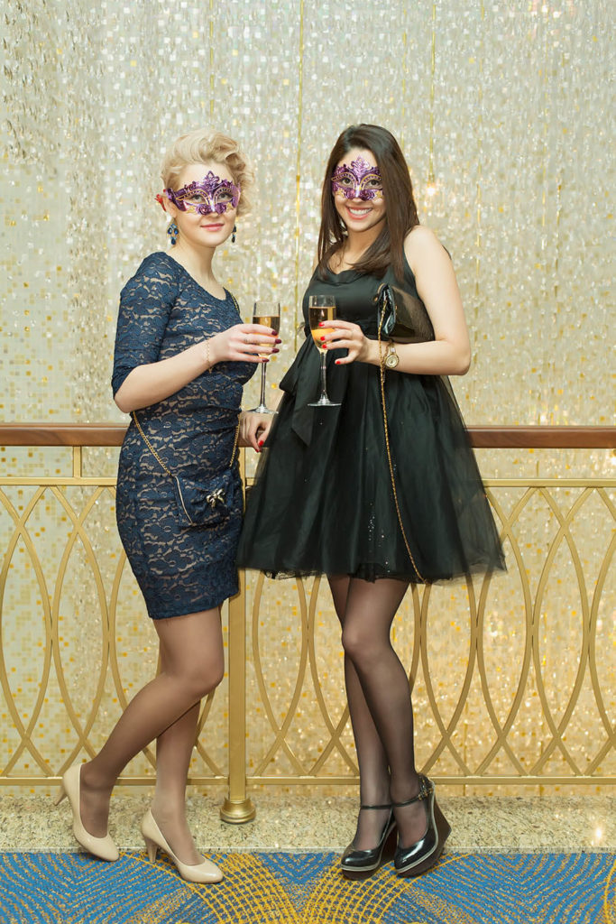 Two women with masks on at corporate event