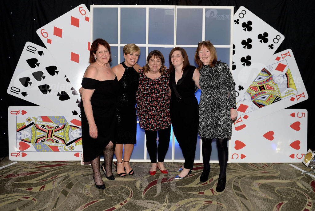 Happy team at company event Play your cards